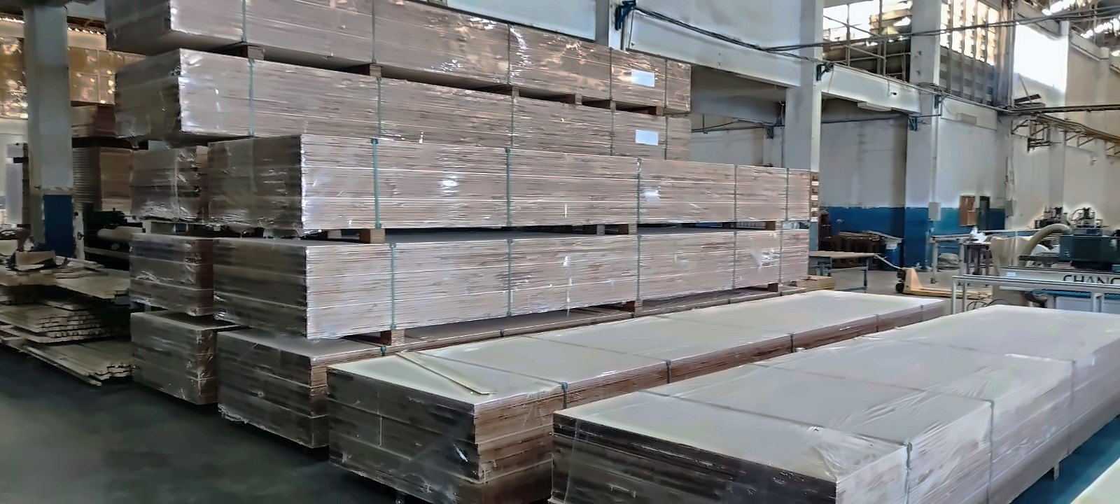 Wrapped packs of LVL and plywood stacked in the PML EasBeam factory, ready for dispatch