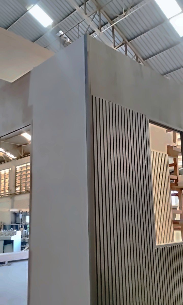 Finished building module with grey panels and dark vertical slatted cladding